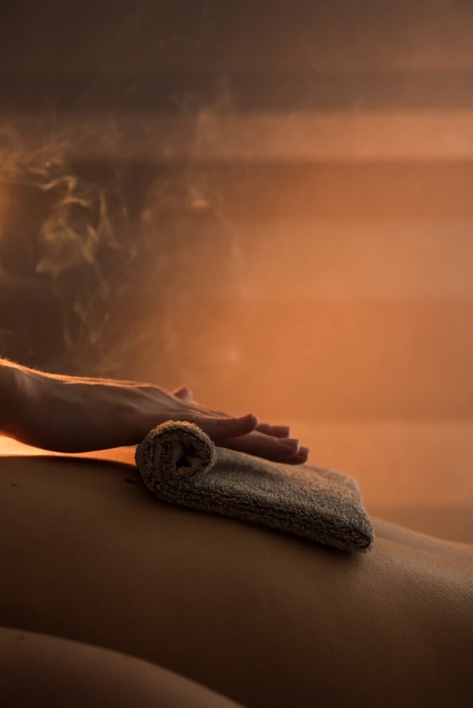 close-up-therapist-hand-massaging-woman-s-back-with-hot-towel-spa (1)